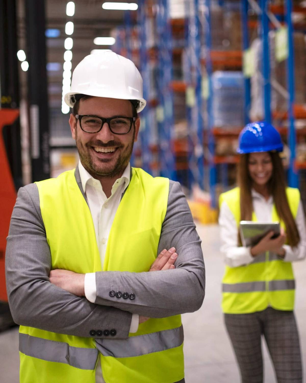 portrait-successful-warehouse-worker-supervisor-with-crossed-arms-standing-large-storage-distribution-area